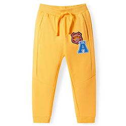 Babyhug Terry Knit Full Length Cut & Sew Track Pants with Sport Theme & Text Print - Yellow